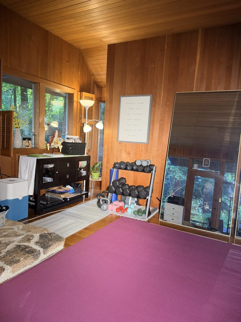 Workout room at Confident Core Studio, with exercise mats, mirrors, and weights