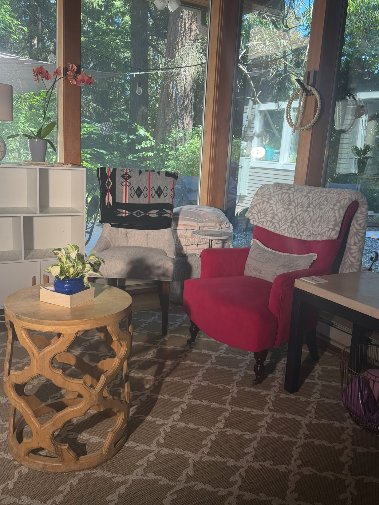 The studio's support and education room, with chairs, plants, and a view of the trees